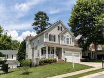 Charming two-story home with a well-manicured lawn and a welcoming front porch at 8001 Strawberry Meadows St, Raleigh, NC 27613