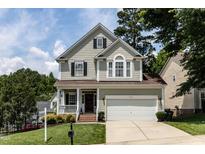 Charming two-story home with a manicured lawn, covered porch and a two car garage at 8001 Strawberry Meadows St, Raleigh, NC 27613