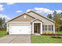 Charming single-Gathering home with a two-car garage, manicured lawn, and stone accents at 100 Flue Ct, Oxford, NC 27565
