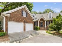 Charming brick home with a two-car garage and well-manicured landscaping at 1003 Blackberry Ln, Durham, NC 27712