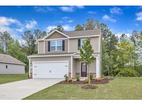 Charming two-story home with a well-manicured lawn, inviting entrance, and attached two-car garage at 106 Flue Ct, Oxford, NC 27565