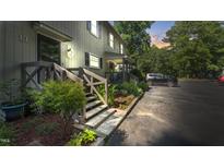 Charming townhome exterior with a well-manicured lawn and stairs to the front door at 11 Willow Bridge Dr, Durham, NC 27707