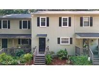 Charming townhome with a welcoming front door, wooden steps, and well-maintained landscaping at 11 Willow Bridge Dr, Durham, NC 27707