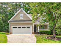 Charming home featuring a two-car garage, well-manicured lawn, and inviting front porch at 113 Chestone Ct, Cary, NC 27513