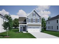 Charming two-story home with a two-car garage, manicured lawn, and beautiful architectural details at 1205 Westerland Way # 25, Durham, NC 27703