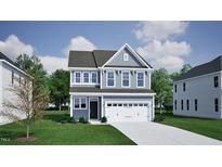 Charming two-story home featuring a well-manicured lawn and a two-car garage at 1307 Westerland Way # 16, Durham, NC 27703