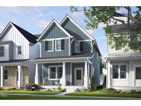 Charming blue two-story home with inviting front porch and well-manicured lawn at 1537 Piney Fls Dr, Wendell, NC 27591
