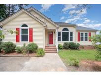 Charming single-Gathering home with a red front door and beautiful landscaped yard at 220 Needle Park Dr, Cary, NC 27513