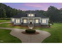 Charming single-Gathering home with a circular driveway and manicured lawn at 2493 Nc-242, Benson, NC 27504