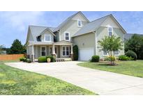 Two-story home with a well-manicured lawn, large driveway, and attached garage at 25 Ruth Cir, Fuquay Varina, NC 27526