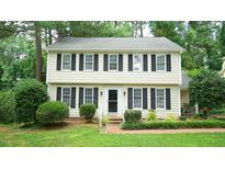 Charming two-story home with black shutters and beautifully landscaped front yard at 304 Ramblewood Dr, Raleigh, NC 27609