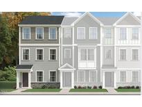 Charming townhome showcasing a stylish three-story design with varied siding and a welcoming front entrance at 324 Carolina Springs Blvd, Apex, NC 27539