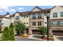 Charming brick and siding townhome with an attached garage and manicured landscaping, inviting curb appeal at 341 View Dr, Morrisville, NC 27560