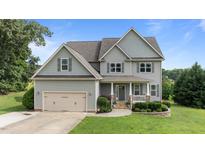 Charming two-story home with gray siding, manicured lawn, and inviting front porch at 3525 Daisy Ln, Wake Forest, NC 27587