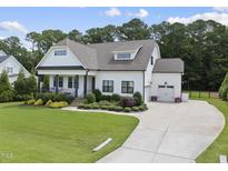 Charming, modern farmhouse-style home featuring a well-manicured lawn and a spacious driveway at 3829 Sleepy Brook Ln, Apex, NC 27539