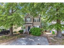 Charming two-story home with a well-maintained front yard and a classic facade, showcasing its inviting curb appeal at 4825 Windbreak Ln, Raleigh, NC 27616