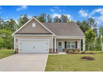 Charming single-Gathering home featuring a two-car garage, landscaped yard, and welcoming front porch at 503 Benton Dr, Oxford, NC 27565