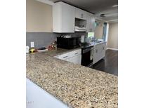 Modern kitchen featuring granite countertops, stainless steel appliances, and white cabinetry at 57 Winding Ridge Rdg, Sanford, NC 27332