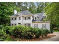 Charming two-story traditional home featuring neutral siding, dormers and professional landscaping at 5809 N Hawthorne Way, Raleigh, NC 27603