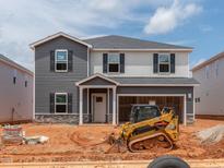 New two-story home showcasing gray and white siding, black shutters, and an attached two-car garage at 752 Deschutes Dr, Garner, NC 27529