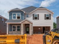 Two-story home featuring blue and white siding, a brick entryway, and an attached garage at 756 Deschutes Dr, Garner, NC 27529