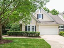Charming two-story home with landscaped yard, black shutters, and a two-car garage in a peaceful neighborhood at 101 Lake Tillery Dr, Cary, NC 27519