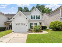 Charming two-story home featuring a garage, landscaped front yard, and green shutters at 1016 Goldmist Ln, Durham, NC 27713