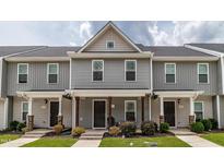 Charming townhouse with a covered front porch and well-maintained landscaping, showcasing curb appeal at 121 Longleaf Pine St, Clayton, NC 27527
