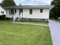 Charming home with a well-manicured lawn and inviting front entrance at 129 S Bullock St, Henderson, NC 27536