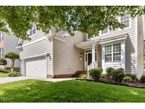 Charming home with a well-manicured lawn, two-car garage, and inviting front porch at 1304 Trailing Rose Ct, Wake Forest, NC 27587