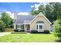 Charming home with a manicured lawn and mature landscaping creating a welcoming curb appeal at 1309 Sweet Charm Ln, Knightdale, NC 27545