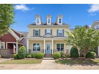 Charming two-story home with yellow siding, dormer windows, and a covered front porch at 1330 Rodessa, Raleigh, NC 27607