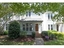 Charming two-story townhome with well-maintained landscaping and inviting front entrance at 146 Greenmont Ln, Cary, NC 27511