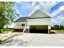 Charming exterior view of a new home featuring a two-car garage and inviting front porch at 168 Clayton Rd, Princeton, NC 27569