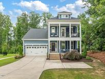 Charming two-story home with a two car garage and inviting double porches at 1804 Amberly Ledge Way, Cary, NC 27519