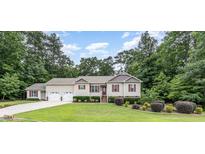 Charming two-story home featuring a well-manicured lawn, an attached two car garage and mature landscaping at 281 Kinsman Ct, Fuquay Varina, NC 27526