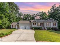 Charming home features a two-car garage, red shutters, beautiful landscaping, and a welcoming front porch at 281 Kinsman Ct, Fuquay Varina, NC 27526
