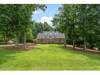 Charming brick home with a large front yard and mature trees at 305 Lochridge Dr, Roxboro, NC 27573