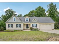 Charming single-Gathering home featuring a two-car garage and well-manicured lawn at 33 Bluestone Dr, Smithfield, NC 27577
