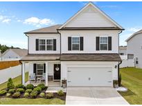 Charming two-story home featuring a two-car garage, inviting front porch, and manicured landscaping at 3613 Cross Timber Ln, Raleigh, NC 27603