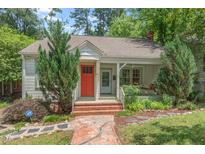 Charming single-story home featuring a front porch and a well-manicured yard at 414 W Markham Ave, Durham, NC 27701