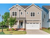 Charming two-story home with a two car garage and inviting curb appeal at 414 Wyndham Dr, Chapel Hill, NC 27516