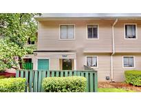 Charming townhome with a private front entrance and lush landscaping creating curb appeal at 4736 Walden Pond Dr, Raleigh, NC 27604