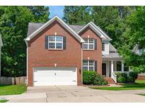 Inviting two-story brick home with a two-car garage and well-maintained landscaping at 4804 Carmen Ln, Durham, NC 27707