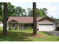 Charming one-story home featuring a well-maintained lawn and a two-car garage at 503 N Franklin Dr, Sanford, NC 27330