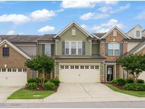 Charming townhome with a two-car garage, beautiful landscaping, and inviting curb appeal at 507 Brier Crossings Loop, Durham, NC 27703