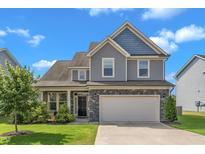 Charming two-story home featuring a two-car garage and beautiful landscaping, offering great curb appeal at 525 Willow Breeze Ct, Zebulon, NC 27597