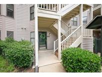 Charming condo entrance with a wreath on the door and well-maintained landscaping at 600 Audubon Lake Dr # 4B11, Durham, NC 27713