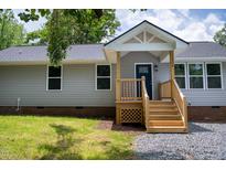 Charming home with a blue front door and a new wooden porch and stairs at 1006 S Second Ave Ave, Siler City, NC 27344