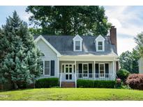 Charming single-Gathering home featuring a cozy front porch and well-maintained landscaping at 101 Stefi Ct, Garner, NC 27529